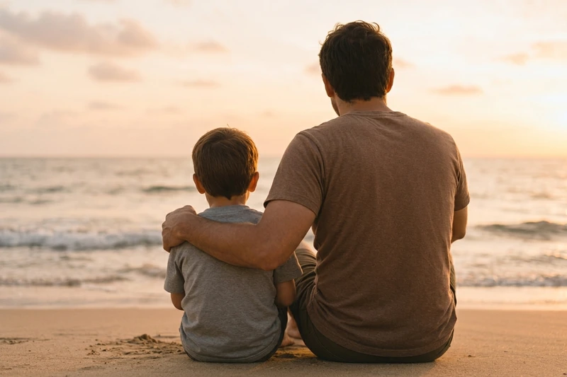 Padre e hijo en la playa mirando el mar, cuota alimentaria